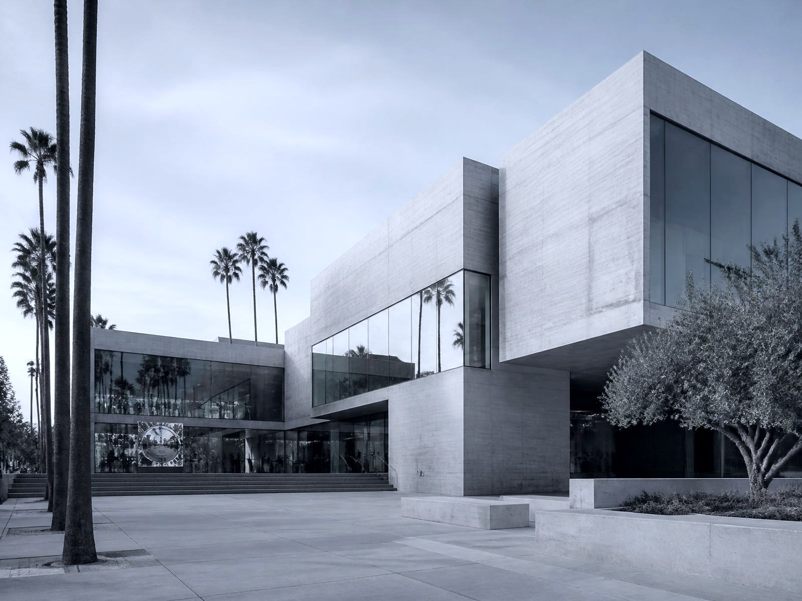 Modernist design centre building with glazed volumes and palm trees in West Hollywood