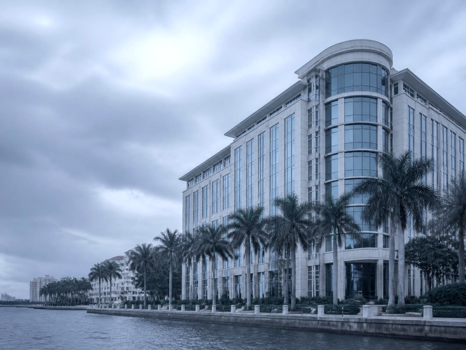Waterfront downtown West Palm Beach office tower with palm trees along the intracoastal