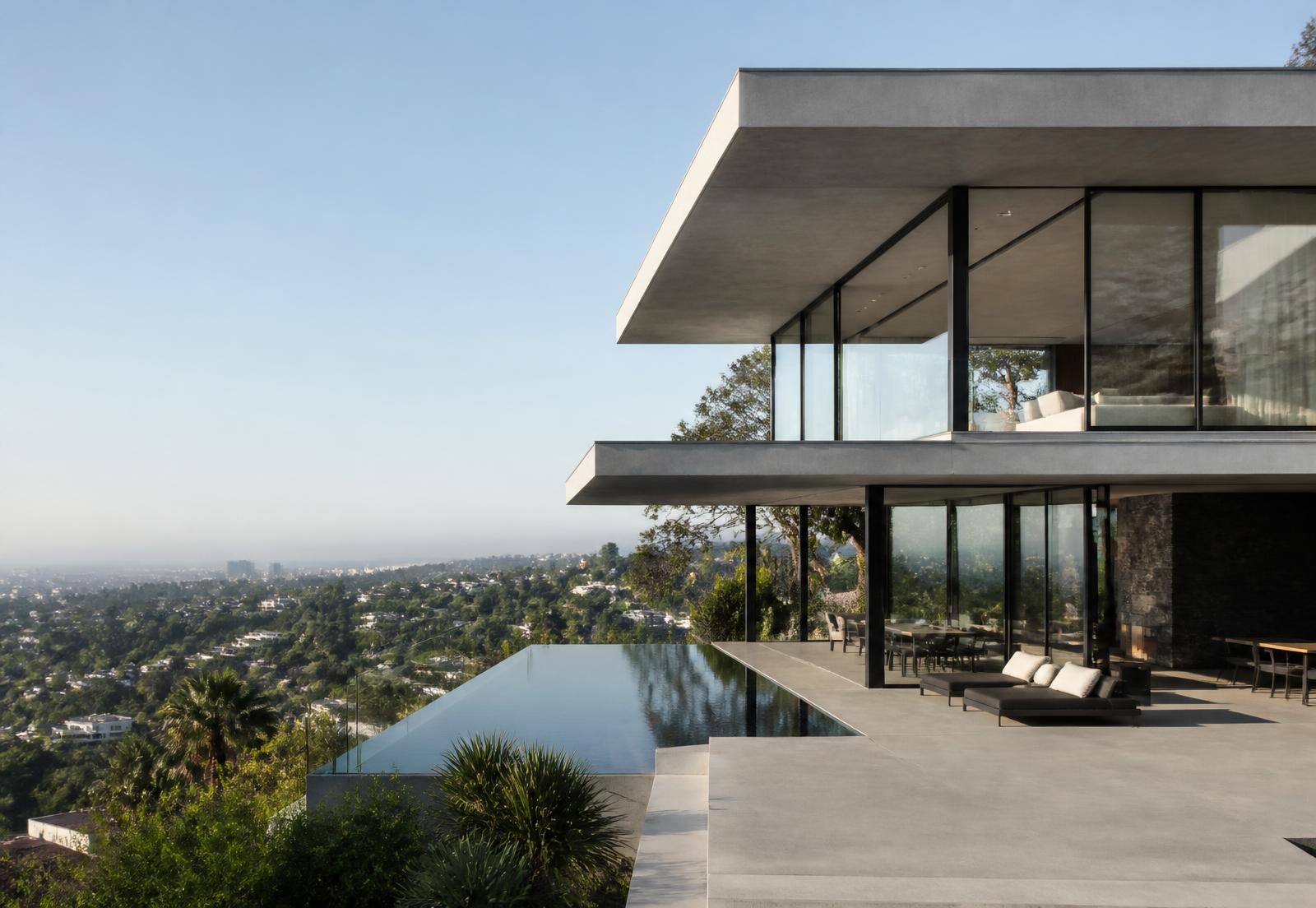 Contemporary hillside residence in Los Angeles with expansive slim black steel glazing and a canyon view